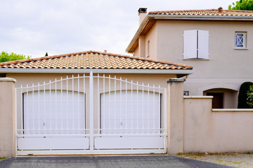 white door steel gate slats portal of suburb house with two entrance garage door