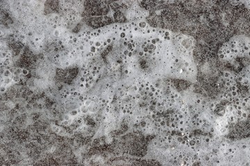 Frozen water. Ice on the beach. Frozen bubbles. Selective focus