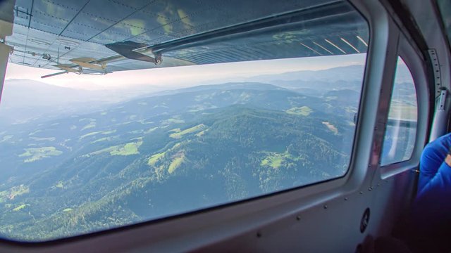 View from the side window of an airplane for the jump of parachutists. Parachute jump plane.