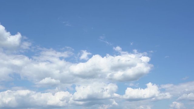 Beautiful sunny panorama of clear blue sky with soft fluffy white clouds. Full hd video footage.