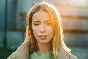 Portrait closeup of young blonde woman posing and looking at camera