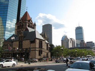 Fototapeta na wymiar Trinity Church in Boston and John Hancock tower on a cloudy Sunny day