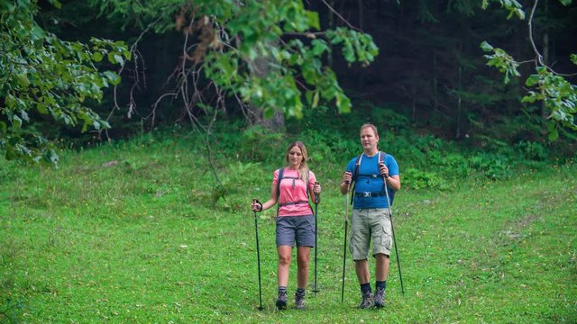 Slow motion of two hikers walking and exploring Slovenian nature
