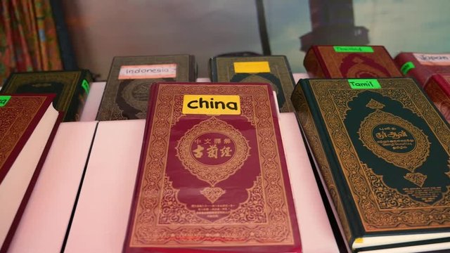 Coran Holy book in different languages on a shelf in a mosque for free (Chinese French Indonesian Korean Tamil Japanese)