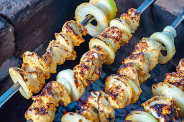 Shish kebab on skewers. Barbecue grill picnic food. Fresh grilled meat close-up. Tasty meal background