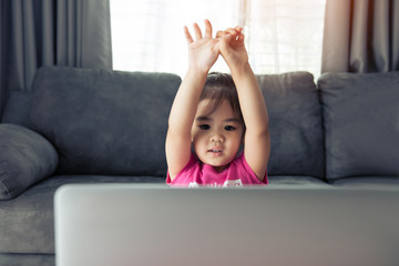 Asian children play with teachers and friends in online learning while the school is closed during the virus epidemic.