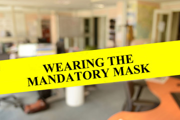 Wearing a mandatory mask written on a yellow banner