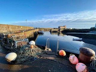 Fishing pots by the edge of a Scottish harbour