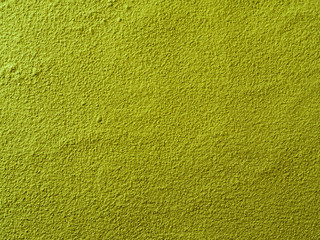 Powdered matcha green tea background. Close up. Dry green maccha powder tea with copy space for text or design