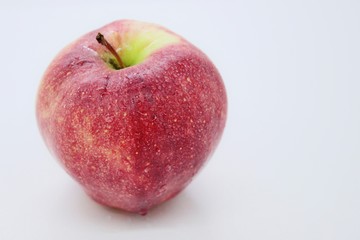 Delicious ripe red juicy beautiful apple located on a white background