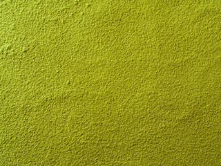 Powdered matcha green tea background. Close up. Dry green maccha powder tea with copy space for text or design