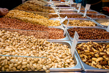 Nut shop with peanuts and pistachios on the counter