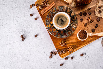 Top down view of a vintage turkish coffee cup with spices, beans and ground coffee powder