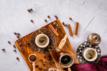 Turkish coffee cup, coffee beans and ground powder on a white background with space for text