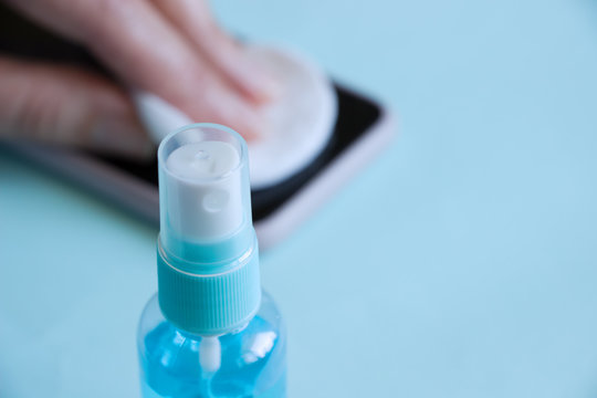 Antiseptic bottle , hand disinfecting cleaning mobile phone . Coronavirus global epidemic. Personal hygiene and coronavirus quarantine concept.