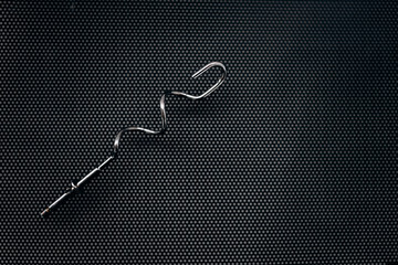 metal corkscrew on a black background