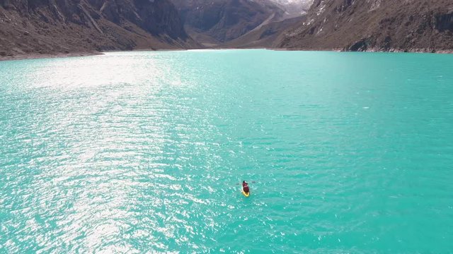 Couple kayaking in middle of paron lake, peruvian andes, huaraz, extreme sport.