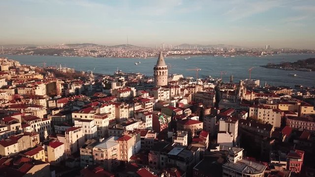 Istanbul Turkey, Cinematic Aerial View of Galata Tower Landmark and Bosphorus Strait on Golden Hour Sunlight
