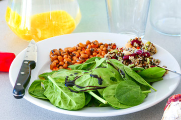 A plate of spinach with balsamic vinegar with couscous