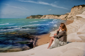 blond girl in dress look on the beautiful beach 