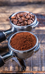 Ground beans in a Coffee machine Coffee handle Filter Holder on a wooden table