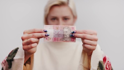 Ten Hryvnia Ukrainian Banknote in the hands of the beautiful blonde woman - Powered by Adobe