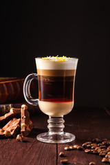 Coffee cocktail based on espresso, Irish whiskey, rum and whipped cream in a transparent glass on a...