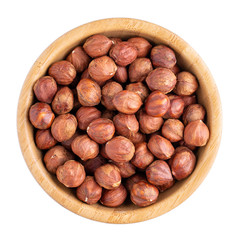 Hazelnuts in wooden bowl isolated on white. Top view.