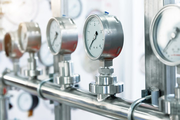 Many pressure gauges mounted on the pipeline.