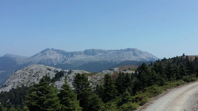 A mountain road overlooking the beautiful landscape of the Eubea Island in Greece - aerial ascend