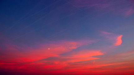 Sunset with pink clouds, light rays and other atmospheric effect.