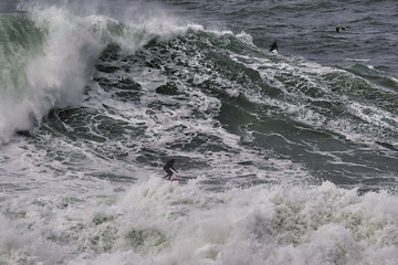 Obraz premium Aerial view of surfer riding big wave on the North Shore, Hawaii. Drone Photo