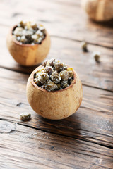 Salty capers in the woodeb bowl