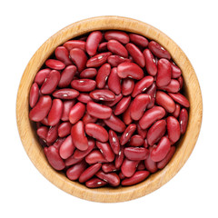 Dried kidney bean in wooden bowl isolated on white. Top view.
