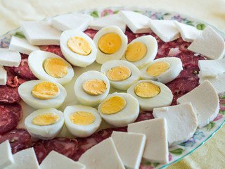 Traditional Neapolitan refreshment dish served for Easter lunch - salami, salted ricotta and hard boiled eggs cut in halves.