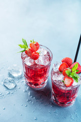 Red cocktail with ice and mint