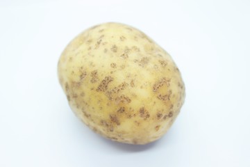Raw ripe potatoes are located on a white background