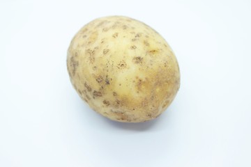 Raw ripe potatoes are located on a white background
