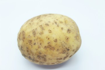 Raw ripe potatoes are located on a white background