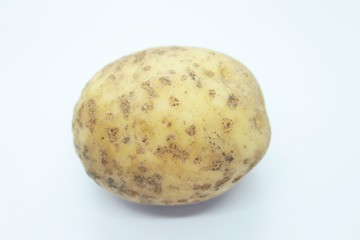 Raw ripe potatoes are located on a white background