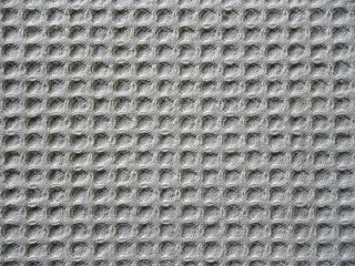 beige fabric material with strong texture, square pattern, close-up
