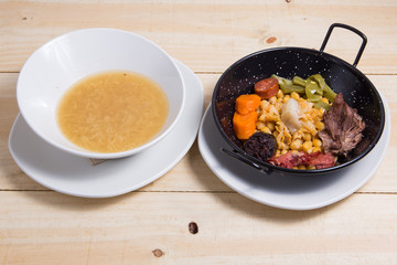 Cocido madrileno, chickpea and pork stew. Plate, food.