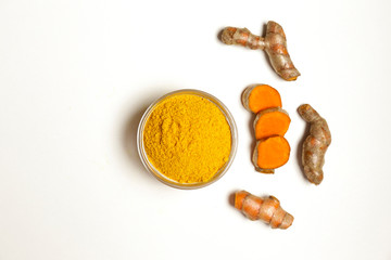 Bunch of ripe dried organic turmeric roots laid in composition on white background. Curcuma at table counter. Clean healthy eating concept. Background, close up, flat lay, top view.