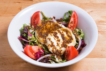 Delicious green salad with goat cheese in the Spanish restaurant.