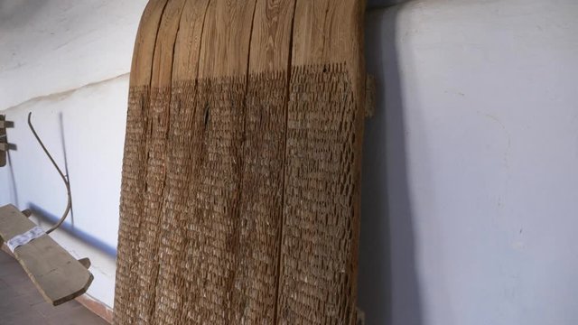 Old tool to separate grain from (a plant), typically with a flail or by the action of a revolving mechanism. truck up movement shot