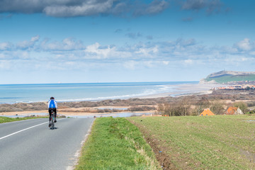 Cyclist on a road in the Opal Coast, France, Pas de Calais - obrazy, fototapety, plakaty
