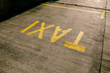 Inscription TAXI on the tarmac. Parking space for taxis.