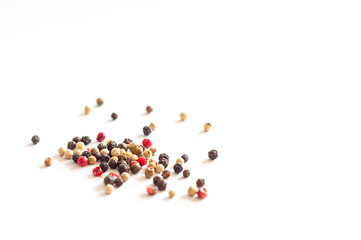 Colorful peppercorns isolated against a white background. Perfect for a spicy dish.