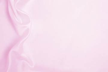 Smooth elegant pink silk or satin texture as wedding background. Luxurious background design