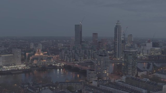 Vauxhall Cross and SIS Building Aerial decent shot at dusk. Aerial, drone descent reveals more buildings, offices and homes. River Thames and Central London. Needs colour grading. 